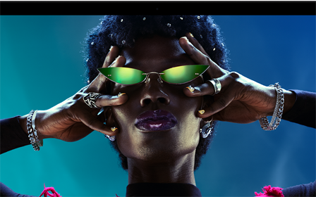 شاشة ملونة على MacBook Pro تُظهر شخصاً يتفاعل بحماس مع الجمهور في إحدى الحفلات، ما يبرز حيوية شاشة ريتنا ليكويد XDR‏ النابضة بالحياة