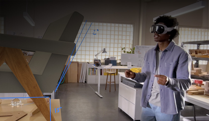 A designer wearing Apple Vision Pro uses hand movements to measure a 3D projection of a chair.