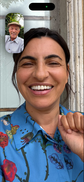 iPhone 17 front screen showing Center stage for video calls feature as two friends talk