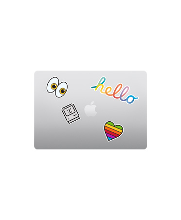 MacBook Air, top exterior, closed, silver colour, multicoloured stickers surrounding Apple logo